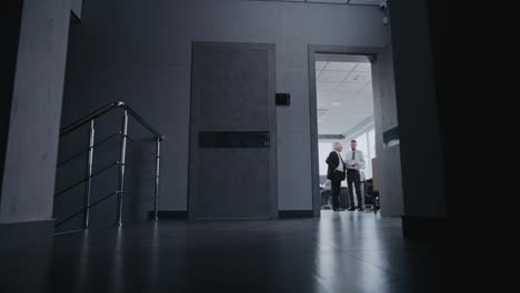 business meeting in office corridor