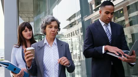 business people interacting with each other while walking