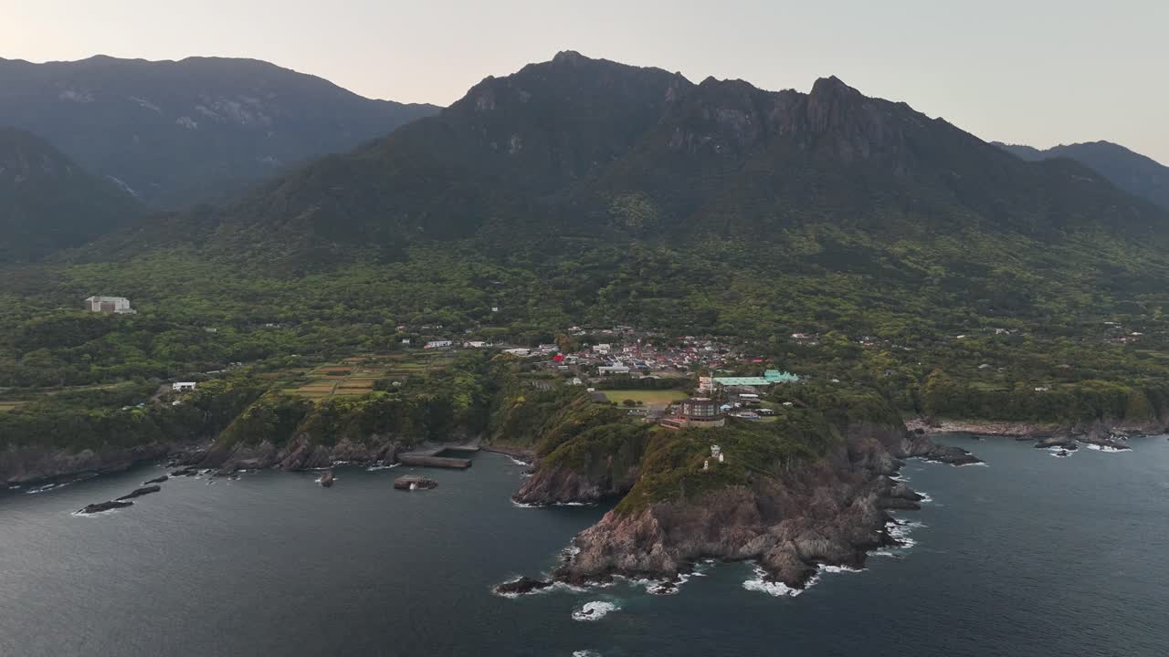 Aerial view of a coastal town nestled amidst mountains