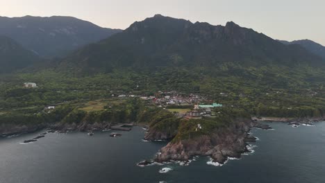 Aerial view of a coastal town nestled amidst mountains