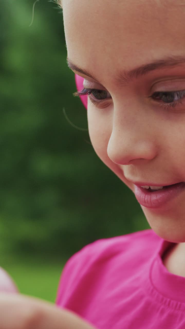 A Young Girl Engrossed in Digital Entertainment: Captivating Moments of Focus and Joy While Using a Mobile Device in an Outdoor Setting
