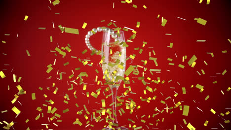 Animation-of-gold-confetti-with-pearl-necklace-falling-into-champagne-glass-on-red-background