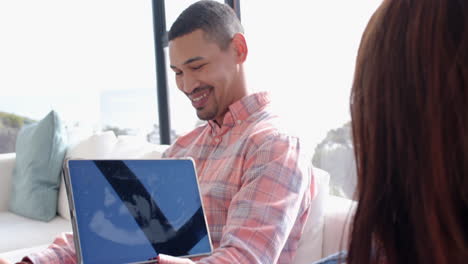 Smiling couple looking at ultrasound image on tablet, celebrating pregnancy together