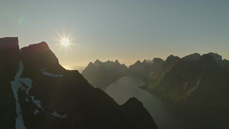 Sun-setting-down-over-mountains-in-Norway,-aerial-view