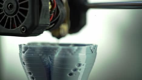 Innovative 3D Printing Process Captured: A Close-Up of the Extruder Creating a Detailed Bowl from Filament with Precision Layers in Progress