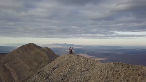 adventurers hiking to the top of mt nebo in salt lake city utah with a panoramic vista - aerial trucking pan