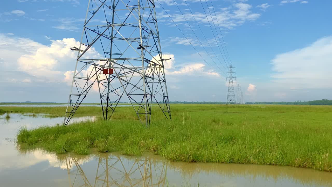 Metal Lattice Tower Carrying High-voltage Electrical Energy Across Wetland In Bangladesh. - pan shot