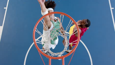 Two-African-American-men-are-playing-basketball-on-an-outdoor-court