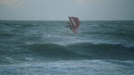 Windsurfer-doing-an-impressive-backflip-maneuver-in-120fps-slow-motion,-1080p