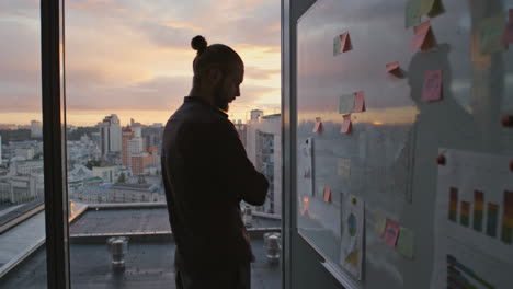 Businessman-silhouette-thinking-notes-evening-office.-Specialist-reading-tasks