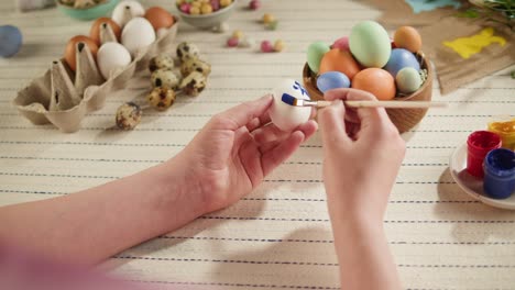 happy easter holiday. coloring eggs top view. woman preparing for easter, painting and decorating eggs. christian celebration, family traditions.