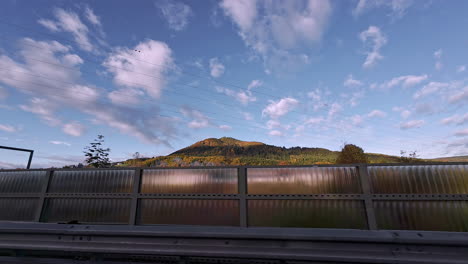 shot from a moving car of moving clouds over the hills