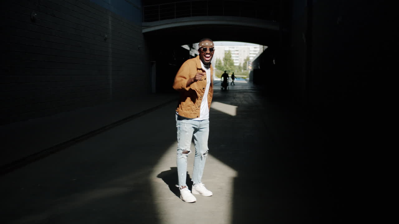 Stylish Man Dancing in an Urban Tunnel