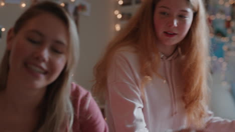 happy teenage girls taking photos together using instant photo camera best friends hanging out at home on weekend enjoying friendship
