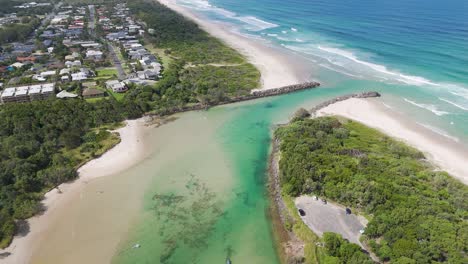 drone captures scenic river and ocean meeting