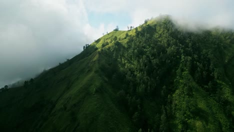 Perched-at-the-edge-of-the-heavens,-Bali's-cloudy-mountain-peaks-offer-a-glimpse-into-a-celestial-realm