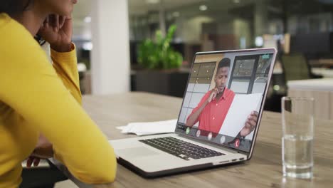 Biracial-businesswoman-using-laptop-for-video-call-with-african-american-business-colleague