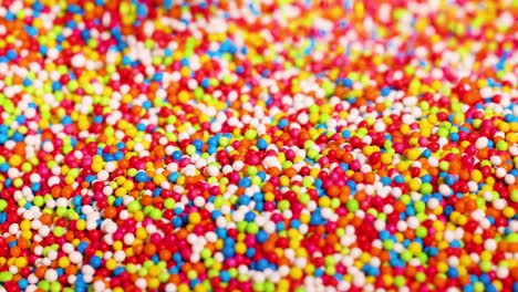 fingers interacting with vibrant candy sprinkles