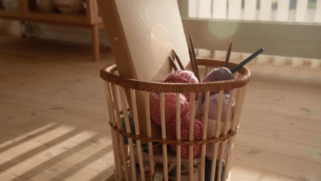 knitting equipment in a basket wool and needles sunlit living room lense flare 4k