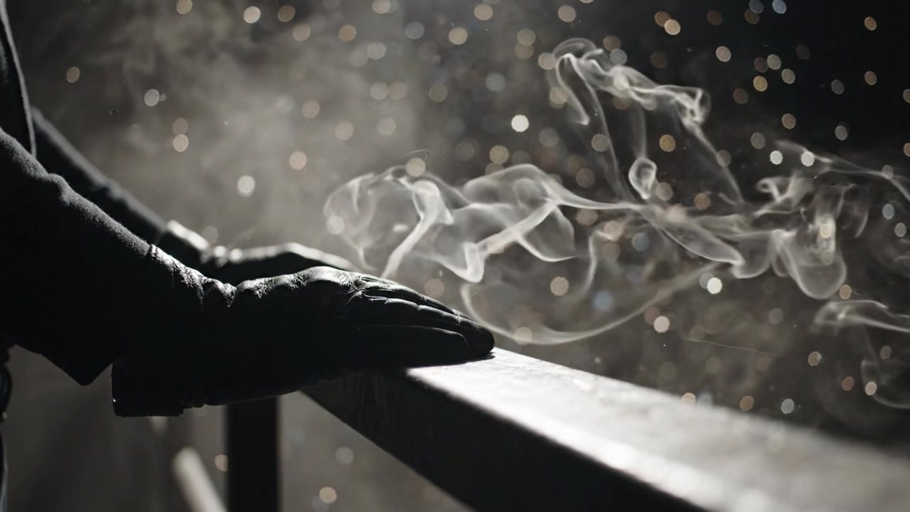 A Mysterious Presence: Gloved Hands Resting on a Railing Enveloped in Smoky Atmosphere with Sparkling Background Lights Capturing Intrigue and Enigma.