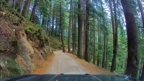 4x4 suv driving through narrow and dangerous roads of wildlife sanctuary in mountains