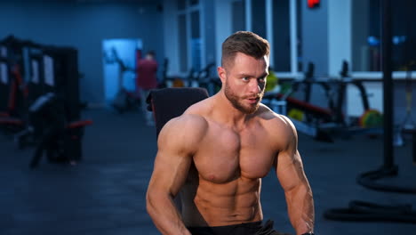 athletic body. shirtless model guy is posing to the camera. strong muscular man with perfect body.
