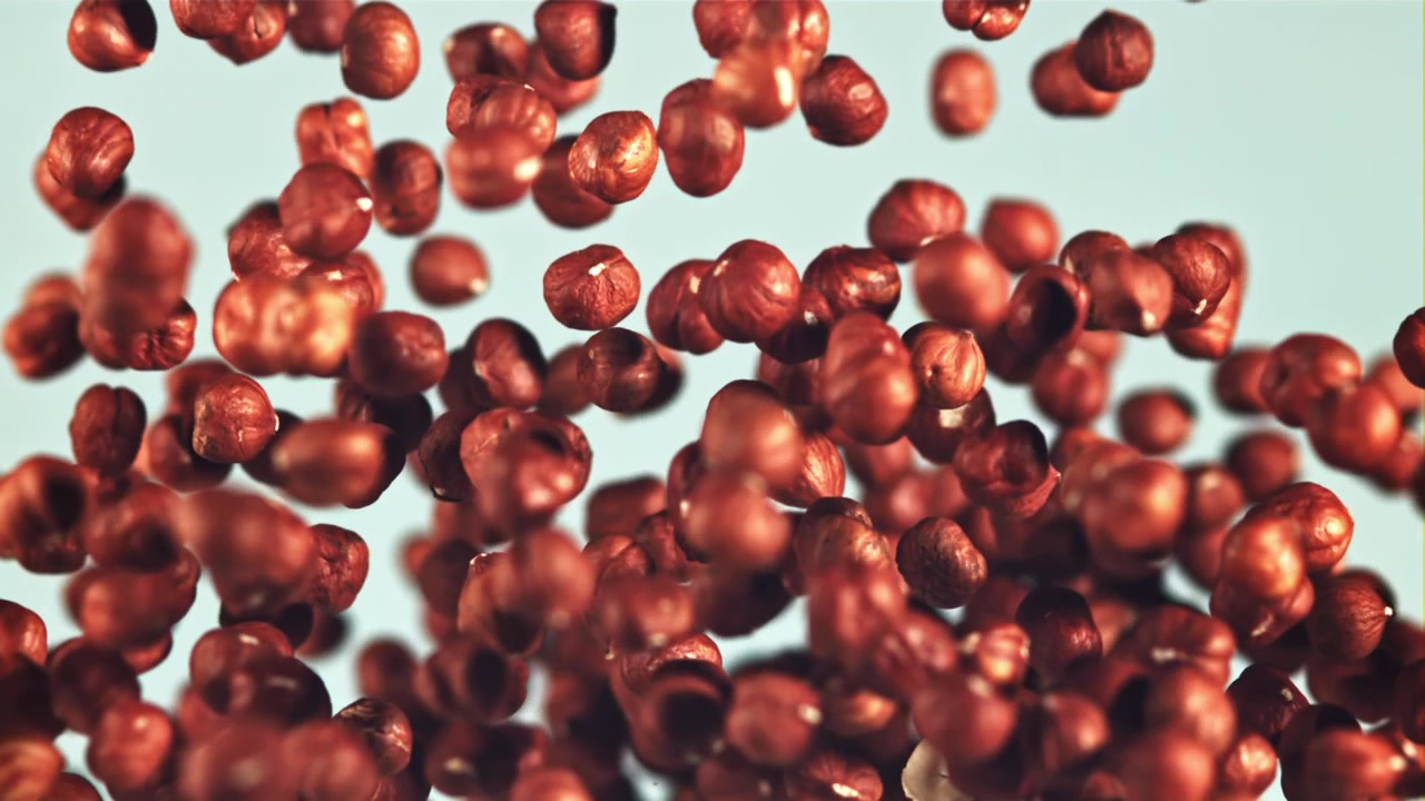 Shelled Hazelnuts Falling and Bouncing in Slow Motion