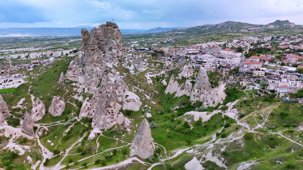 Aerial view of Cappadocia's rocky landscape and town at sunrise in Turkey