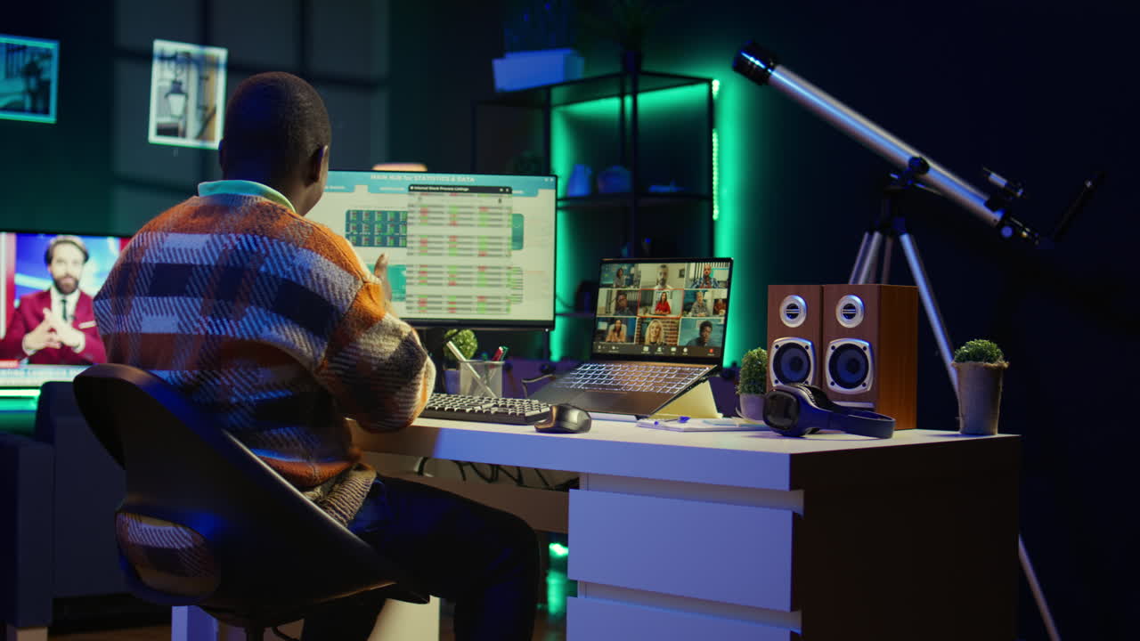 Man working from home with multiple screens and video conference