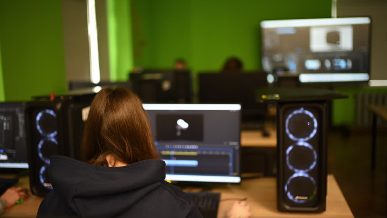 Group of students working on computers in a digital classroom environment
