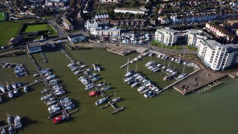 Top-down-aerial-birds-eye-view-boats-in-marina-in-English-coastal-town