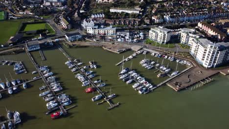 top down aerial birds eye view boats in marina in english coastal town