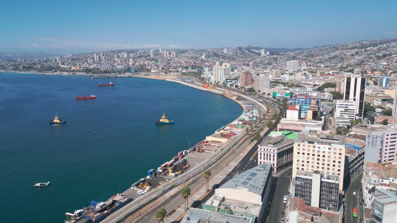 Aerial View of Coastal City With High-Rise Buildings, Curved Waterfront, and Ships on a Clear Day in Valparaiso, Chile