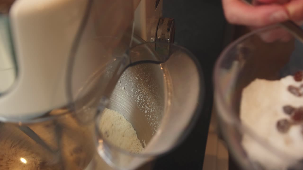 Close-up shot of ingredients being added to the scone mixture whilst in a mixer