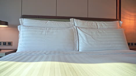 close-up pan of pillows on a hotel bed