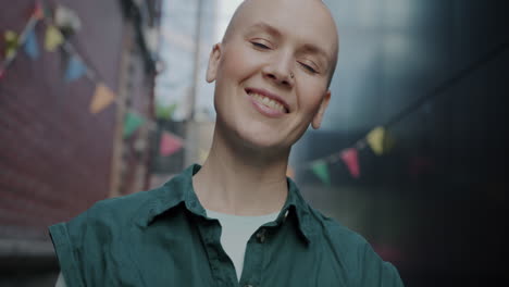 bald woman in urban alley