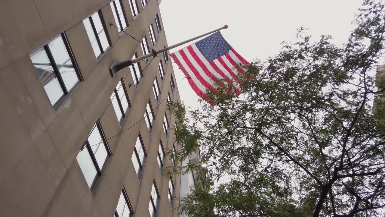 American Flag on Corporate Building in Manhattan, New York USA, Slow Motion Low Angle