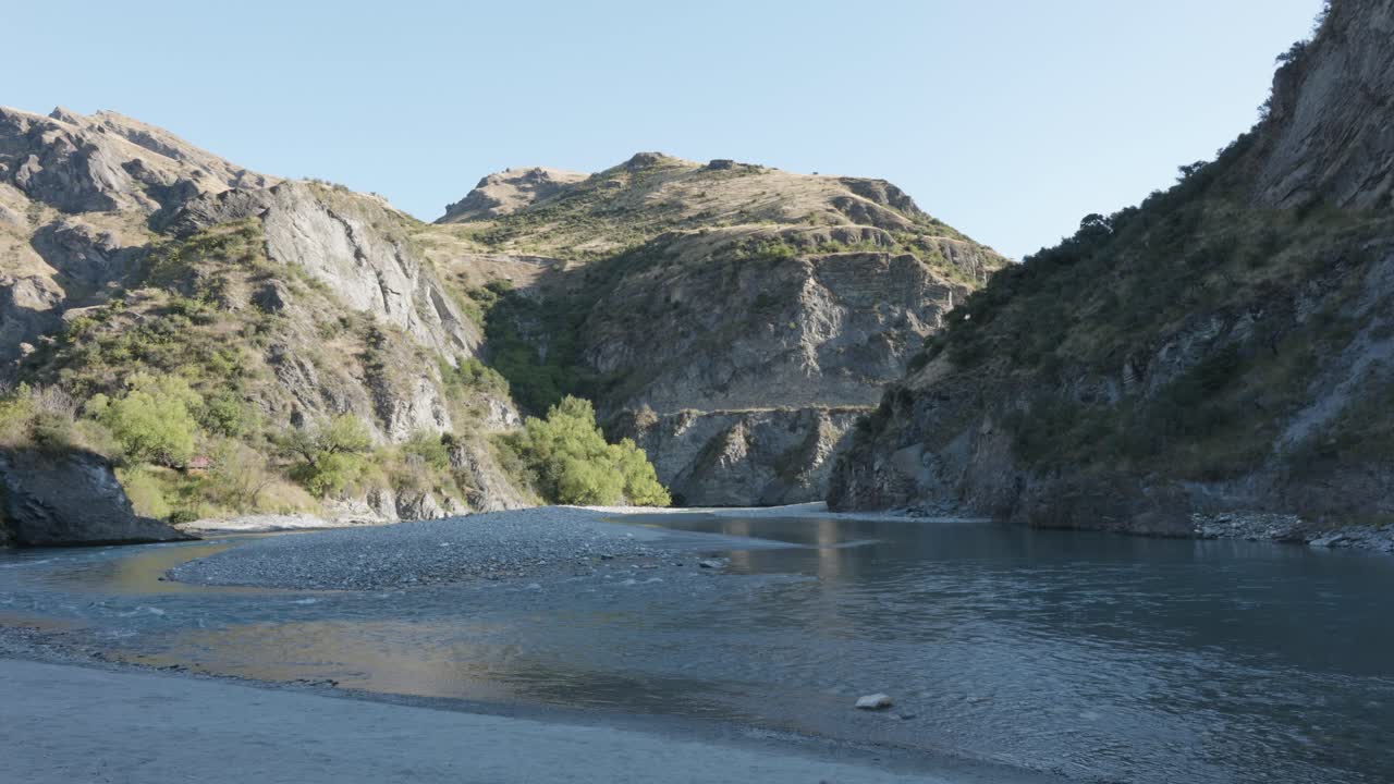 A river flowing in a valley on a sunny summer day at Skippers Canyon, Queenstown, New Zealand.