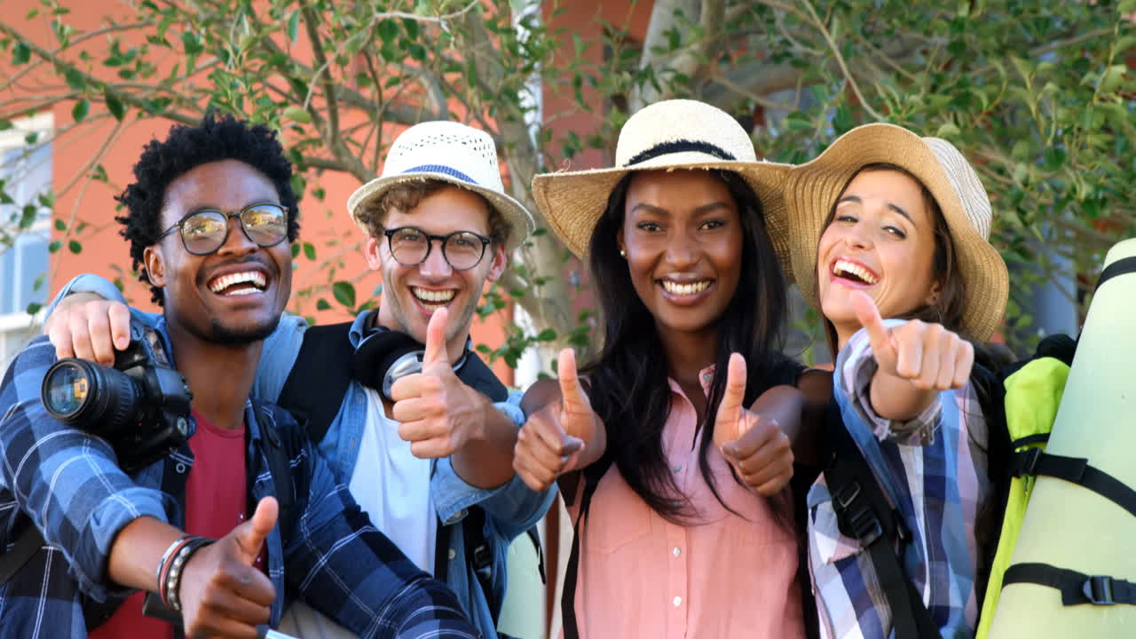 Hipster students are smiling to the camera with thumbs up 