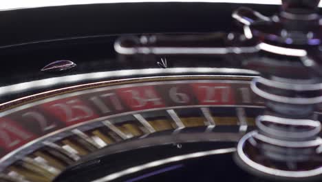 close-up shot of a casino roulette wheel spinning with the ball before landing on a lucky number