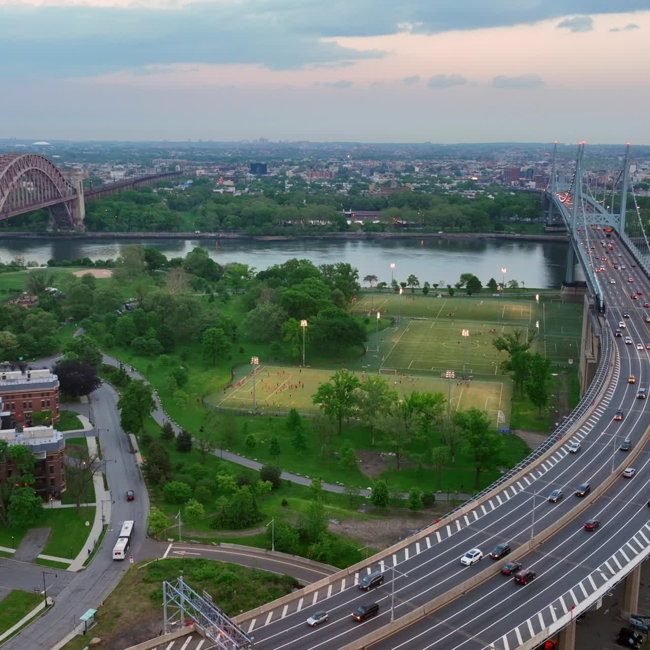 Flyover with numerous moving cars leading to the Triborough bridge in New York. City scenery at sun down