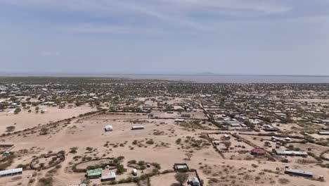 drone, rising view of turkana lake's coastal communities in northern kenya.