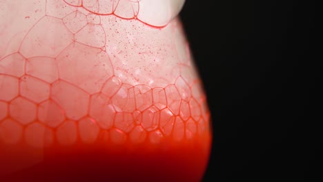 closeup of refreshing soda drink with ice cubes and bubbles in glass cup