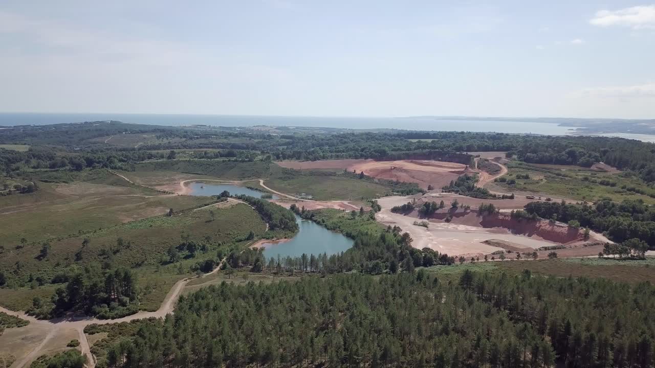 Aerial View of a Quarry Landscape with Lake and Forest