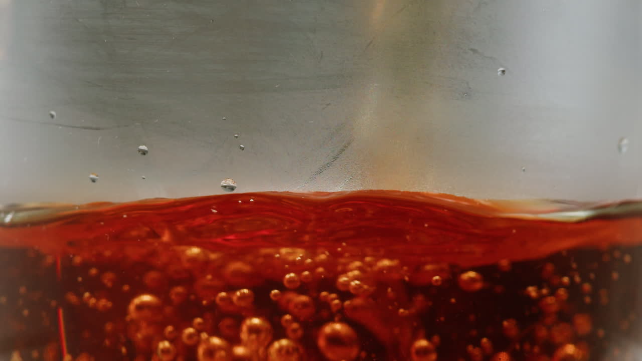 Pouring citrus tea in cup close-up. Fresh hot herbal tea with mint and oranges, healthy morning, detox drink. High quality 4k footage