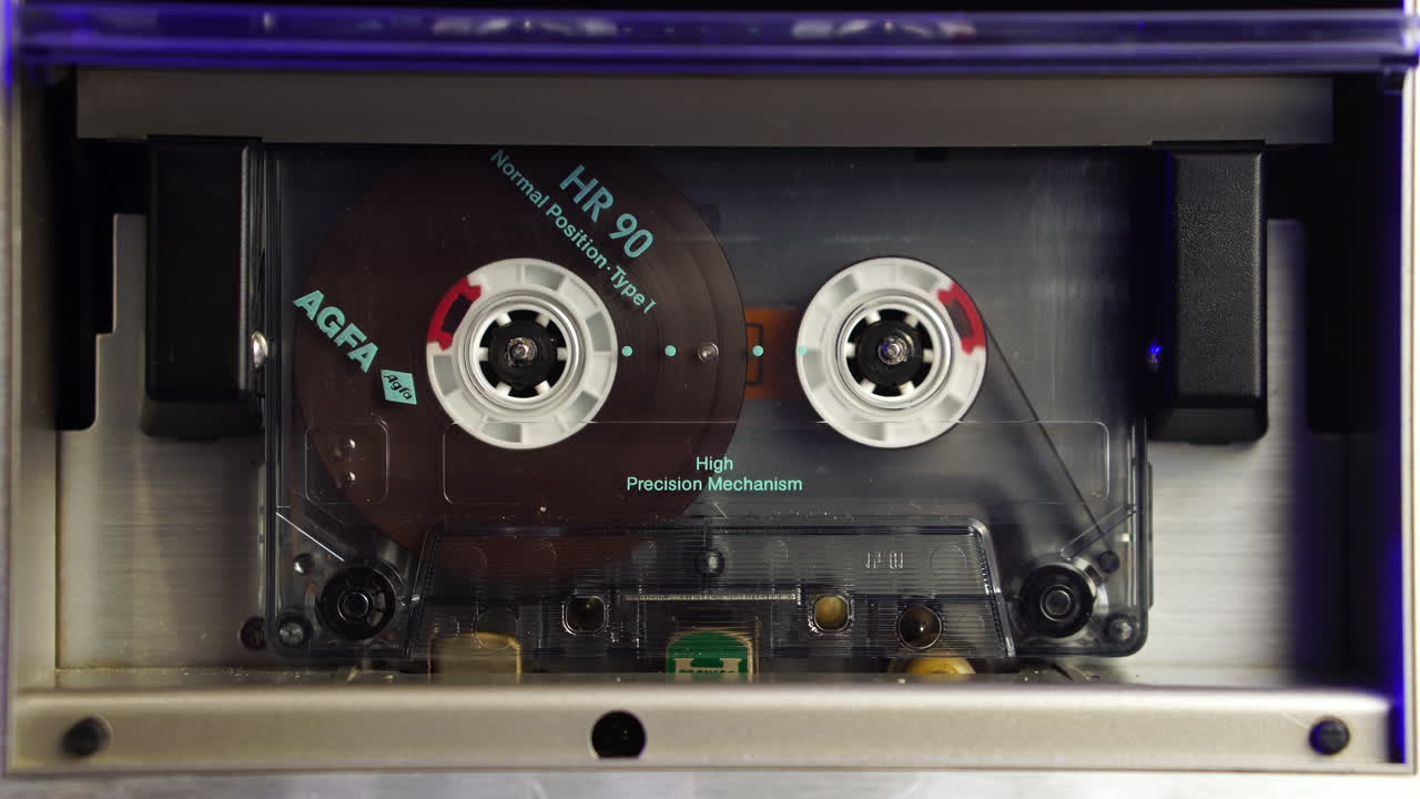 Audio Cassette Tape From 1980's Playing From Start in Vintage Deck Player, Close Up