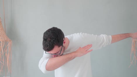 young man doing dabbing, young teen trend move by hipster with beard and glasses