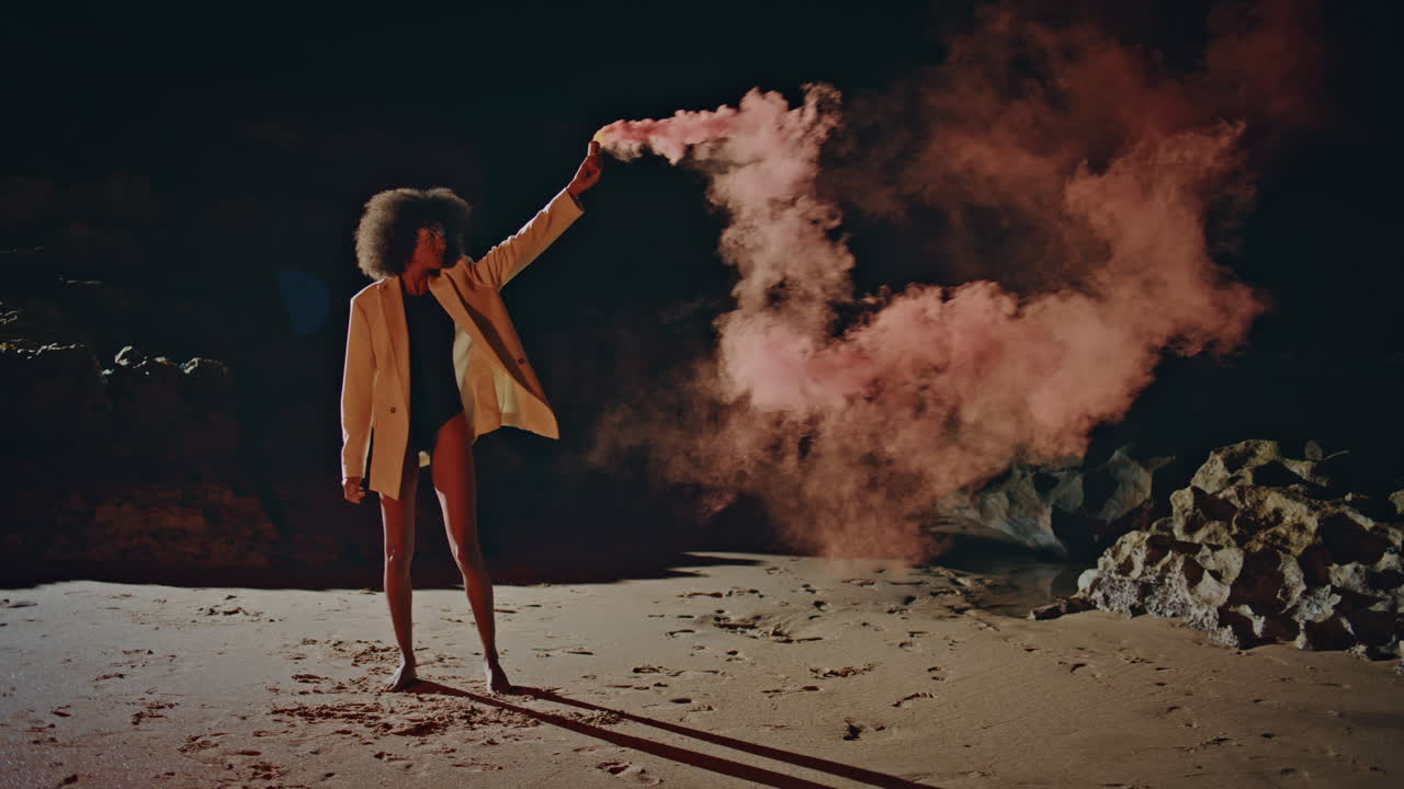 Woman going pink smoke enjoying outdoor party. Sexy   hold bomb