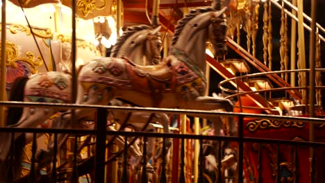 carousel roundabout or merry-go-round with children having fun at festive night