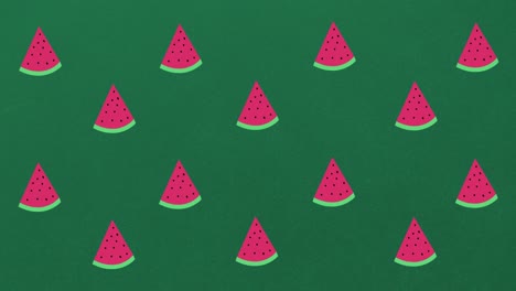 Animation-of-single-watermelons-floating-on-green-background